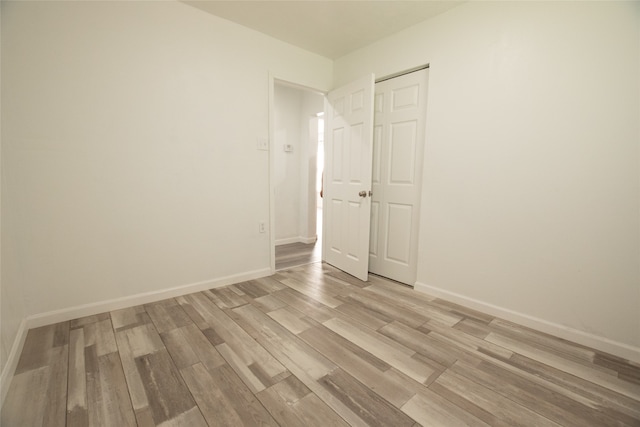 spare room featuring light wood-type flooring