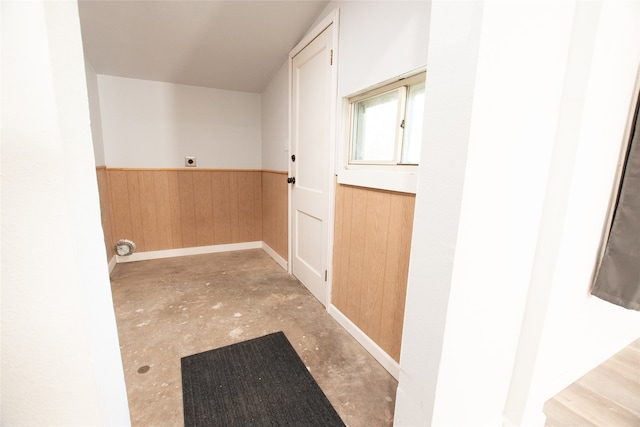 washroom featuring electric dryer hookup and wood walls