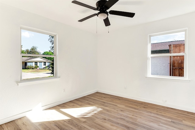 spare room featuring light wood-type flooring and ceiling fan