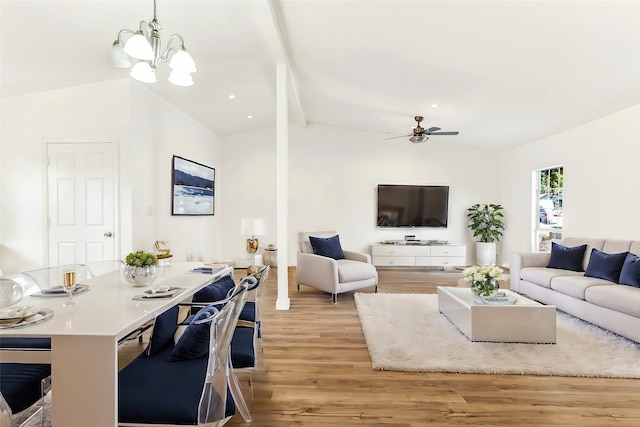 living room featuring light hardwood / wood-style floors, lofted ceiling with beams, and ceiling fan with notable chandelier