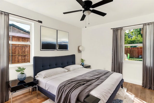 bedroom with hardwood / wood-style floors and ceiling fan