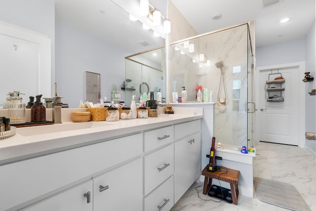 bathroom with a shower with door and vanity