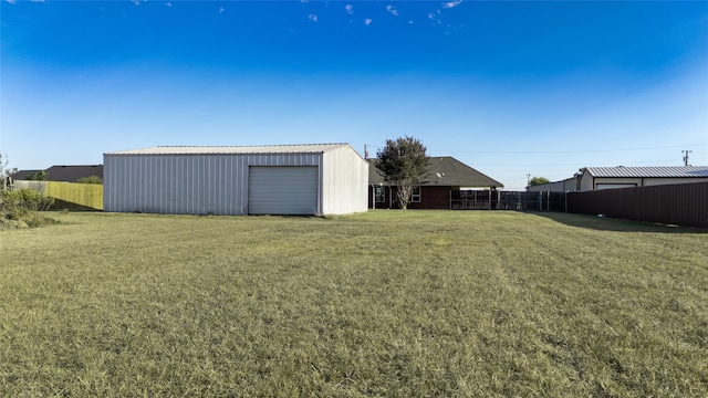 view of yard featuring an outbuilding and a garage