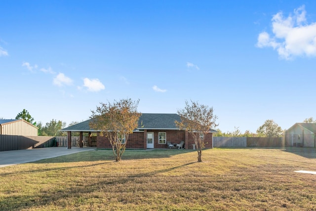 ranch-style home featuring a front yard and a carport