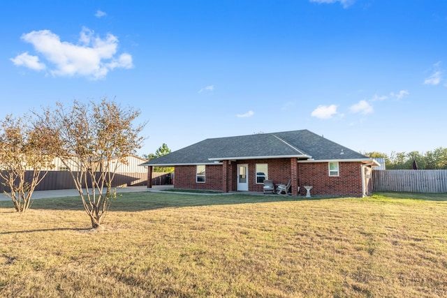 back of property featuring a yard