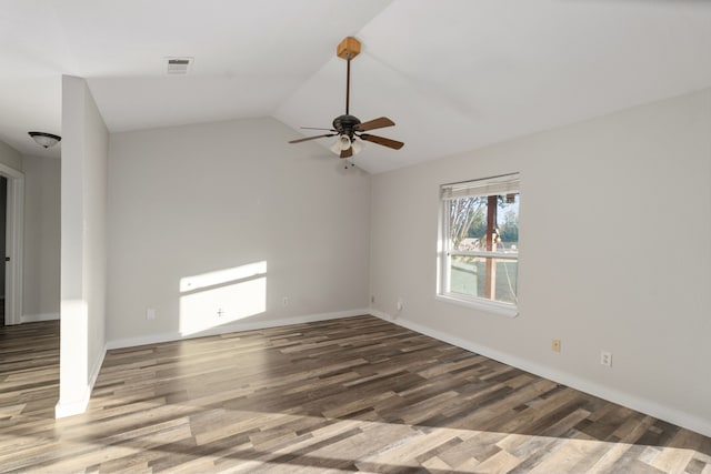 empty room featuring hardwood / wood-style floors, vaulted ceiling, and ceiling fan