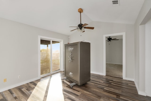 unfurnished room with vaulted ceiling, dark hardwood / wood-style floors, and ceiling fan