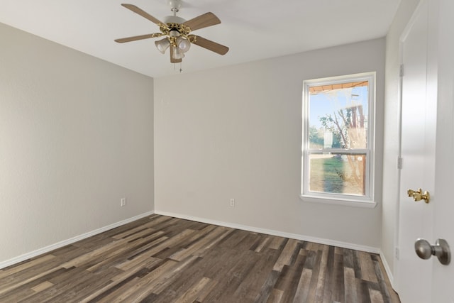 empty room with ceiling fan and dark hardwood / wood-style flooring