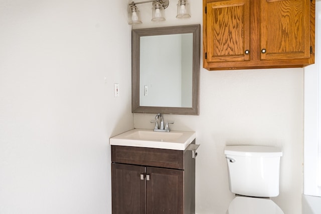 bathroom featuring toilet and vanity