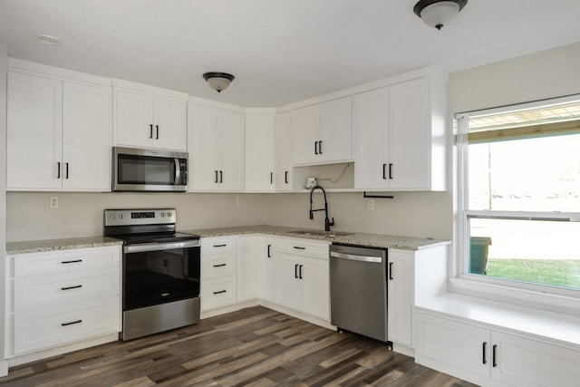 kitchen featuring sink, white cabinetry, dark wood-type flooring, and stainless steel appliances