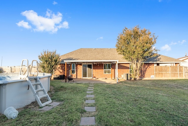 rear view of house featuring a patio and a lawn