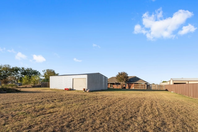 view of yard with an outdoor structure and a garage