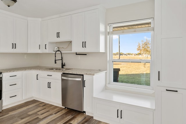 kitchen featuring light stone countertops, sink, white cabinetry, stainless steel dishwasher, and dark wood-type flooring