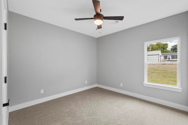 carpeted spare room with ceiling fan