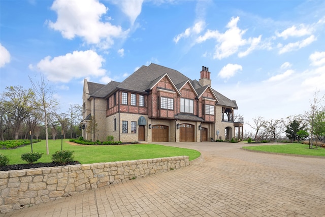 view of front of house with a front yard and a garage