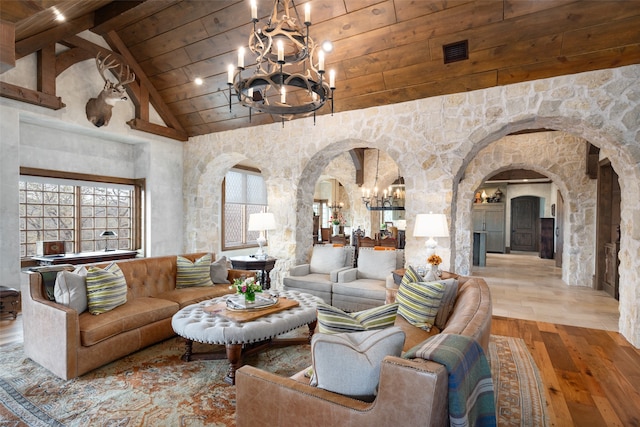 living room featuring light wood-type flooring, high vaulted ceiling, beam ceiling, and wooden ceiling