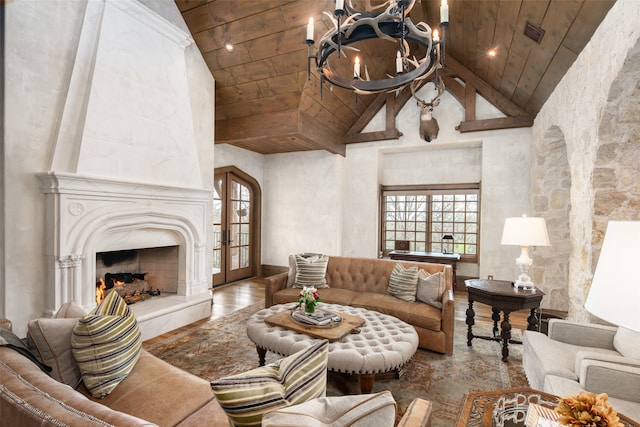 living room with hardwood / wood-style floors, beam ceiling, wood ceiling, french doors, and high vaulted ceiling