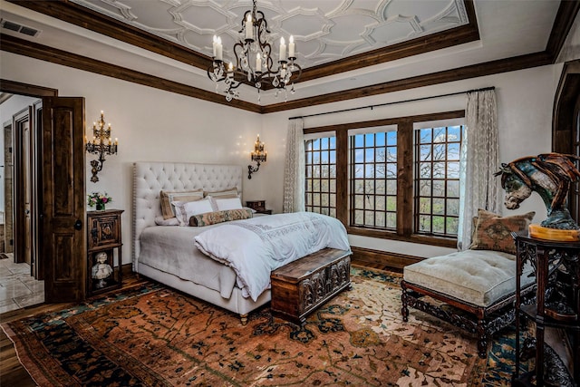 3801 Dugas Rd, Aubrey, TX 76227 - bedroom featuring visible vents, crown molding, wood finished floors, a notable chandelier, and a tray ceiling