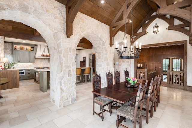 dining area featuring wood ceiling, high vaulted ceiling, a chandelier, and beamed ceiling