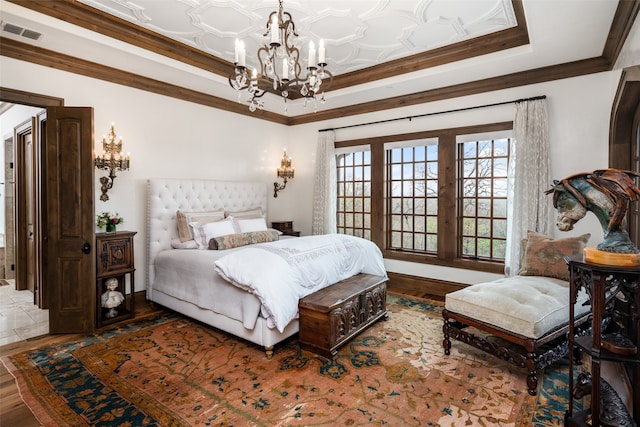 bedroom featuring crown molding, a chandelier, and hardwood / wood-style flooring