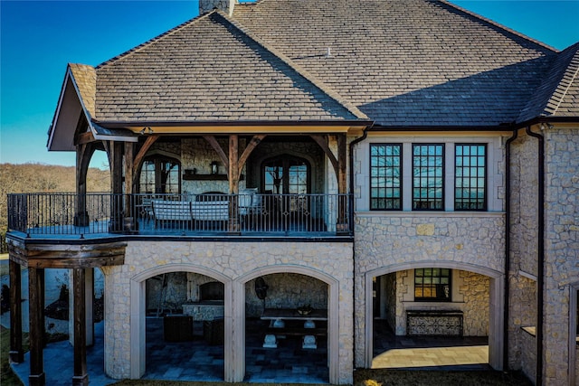 3801 Dugas Rd, Aubrey, TX 76227 - back of house with a balcony, stone siding, a patio, french doors, and a chimney