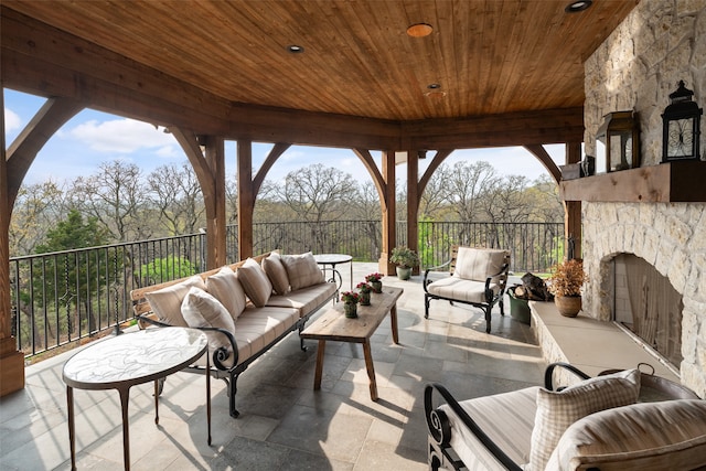 view of patio with an outdoor living space with a fireplace