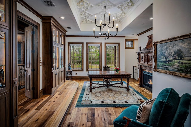 3801 Dugas Rd, Aubrey, TX 76227 - home office featuring visible vents, ornamental molding, an inviting chandelier, light wood-style floors, and a raised ceiling