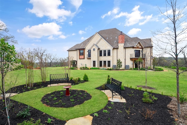 rear view of property featuring a lawn, a patio area, and central air condition unit