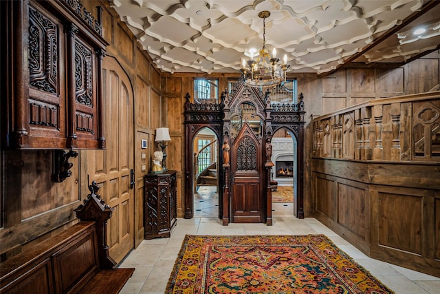 3801 Dugas Rd, Aubrey, TX 76227 - wine cellar with light tile patterned floors, coffered ceiling, wood walls, and a notable chandelier