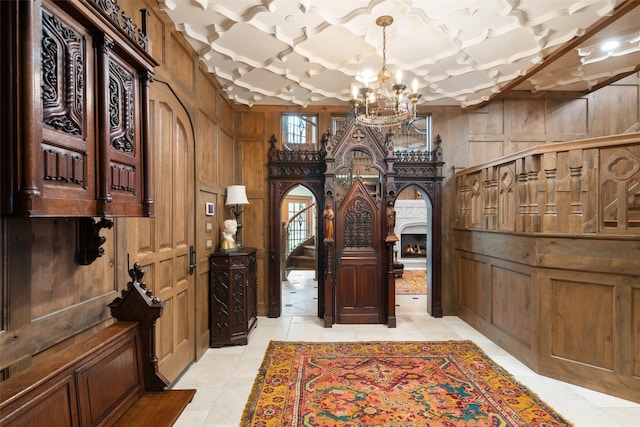 interior space featuring wooden walls and a chandelier