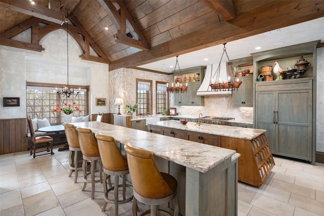 kitchen with a center island with sink, pendant lighting, and plenty of natural light