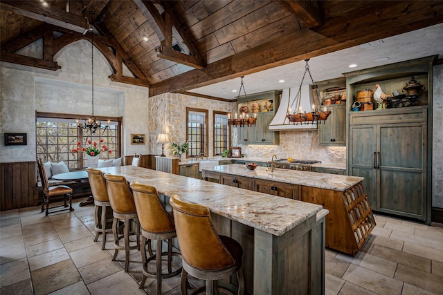 3801 Dugas Rd, Aubrey, TX 76227 - kitchen featuring a chandelier, a center island with sink, custom exhaust hood, and beamed ceiling