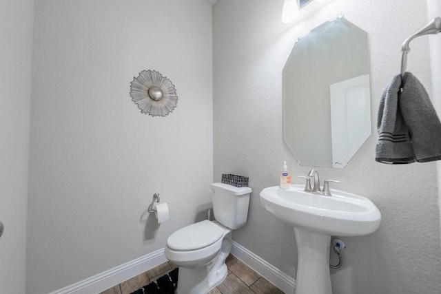 bathroom featuring hardwood / wood-style floors and toilet