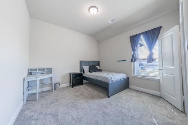 carpeted bedroom featuring vaulted ceiling