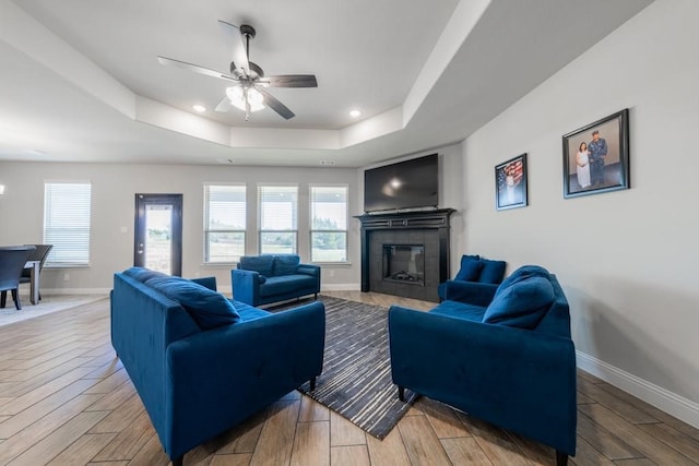 living room with a fireplace, plenty of natural light, and light hardwood / wood-style flooring