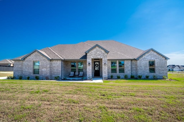 view of front of home with a patio and a front lawn