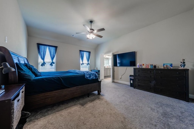 bedroom with ceiling fan, carpet flooring, and ensuite bathroom