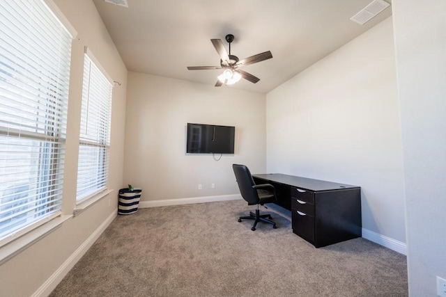 carpeted office featuring plenty of natural light and ceiling fan