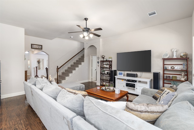 living room featuring ceiling fan and dark hardwood / wood-style flooring