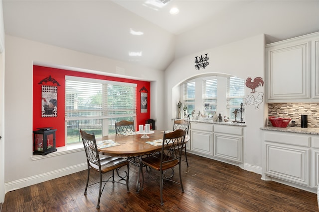 dining area with vaulted ceiling and dark hardwood / wood-style flooring