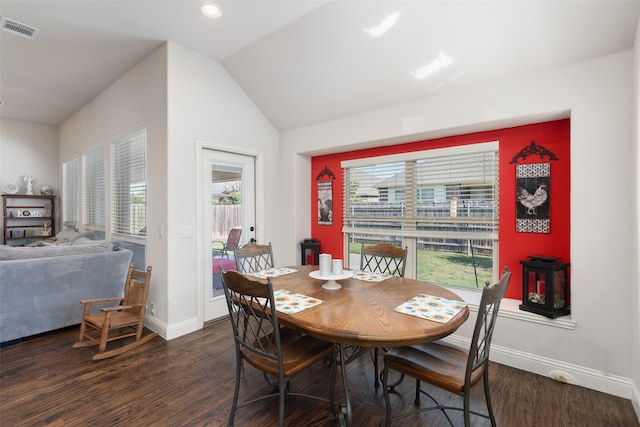 dining space with a healthy amount of sunlight, dark wood-type flooring, and vaulted ceiling