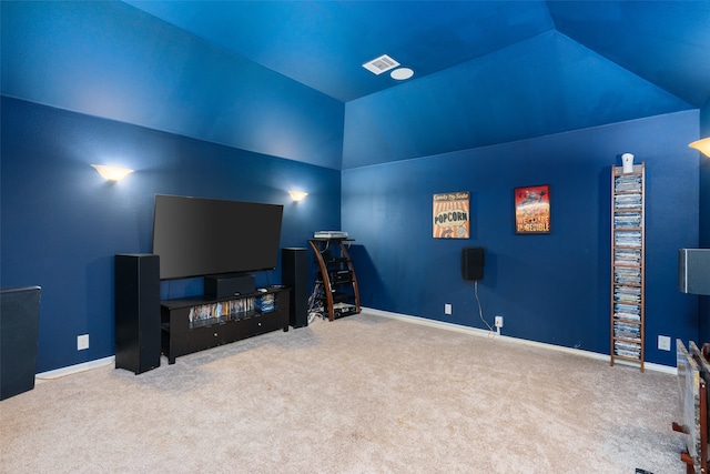 home theater room with lofted ceiling and carpet floors