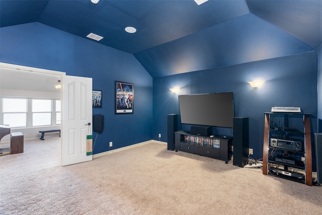 cinema with lofted ceiling and carpet