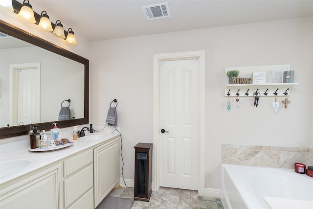 bathroom with vanity and a bathtub