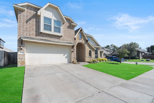 view of front of home featuring a front yard and a garage