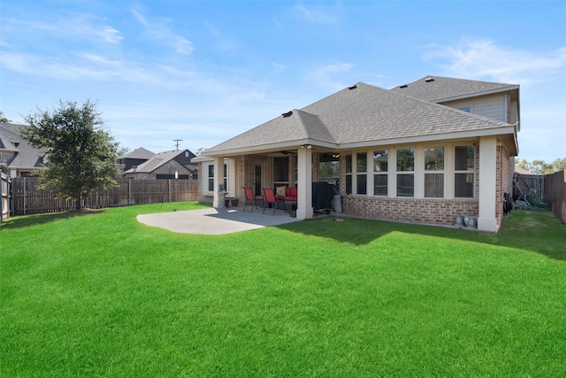 back of property featuring a patio and a lawn