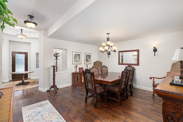 dining area featuring an inviting chandelier and dark hardwood / wood-style floors