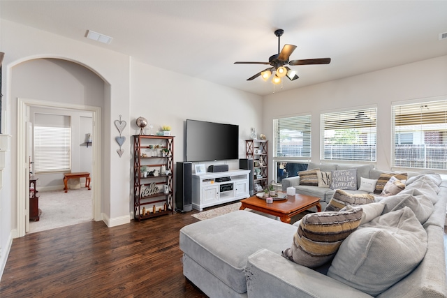 living room with ceiling fan and dark hardwood / wood-style floors