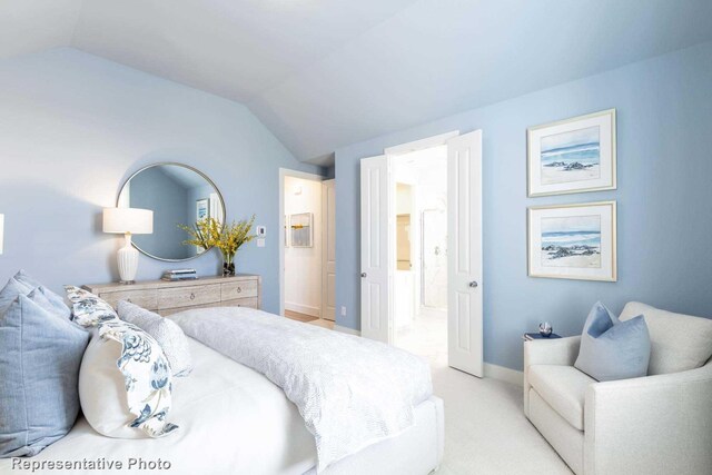 bedroom featuring light colored carpet and lofted ceiling