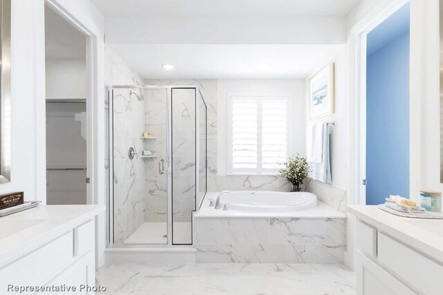 bathroom featuring vanity and separate shower and tub